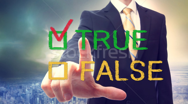 Businessman pointing TRUE Stock photo © Melpomene