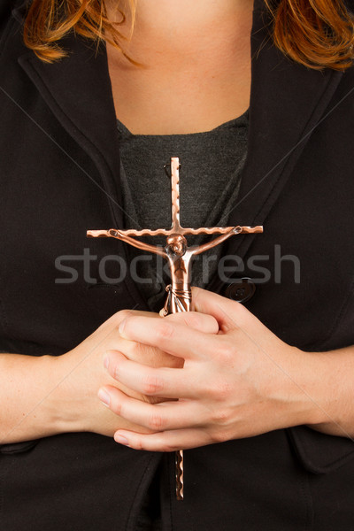 Woman in black with the cross in hands Stock photo © michaklootwijk