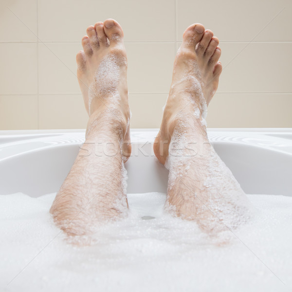 Men's feet in a bathtub, selective focus on toes Stock photo © michaklootwijk