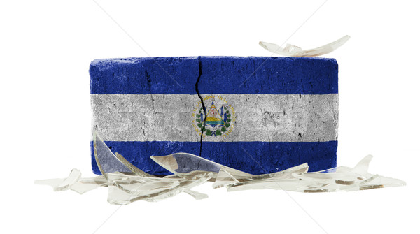 Ladrillo vidrios rotos violencia bandera El Salvador pared Foto stock © michaklootwijk