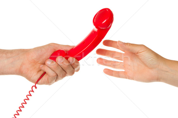 Man giving red telephone to woman Stock photo © michaklootwijk