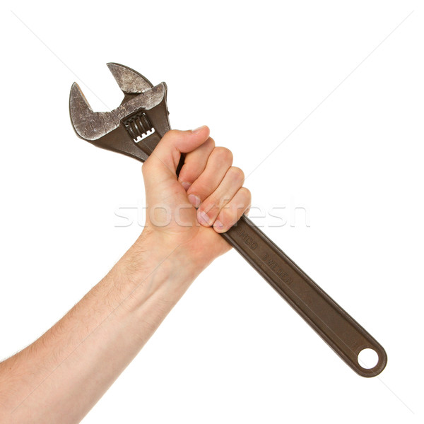 Old rusted adjustable vector wrench in a hand Stock photo © michaklootwijk