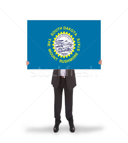 Stock photo: Smiling businessman holding a big card, flag of South Dakota