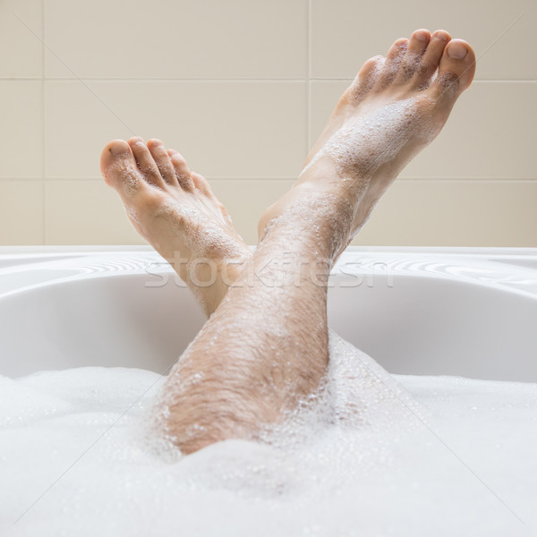 Men's feet in a bathtub, selective focus on toes Stock photo © michaklootwijk