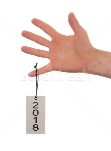 Hand holding a tag - New year - 2018 Stock photo © michaklootwijk