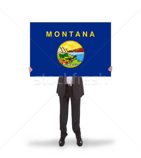 Smiling businessman holding a big card, flag of Montana Stock photo © michaklootwijk