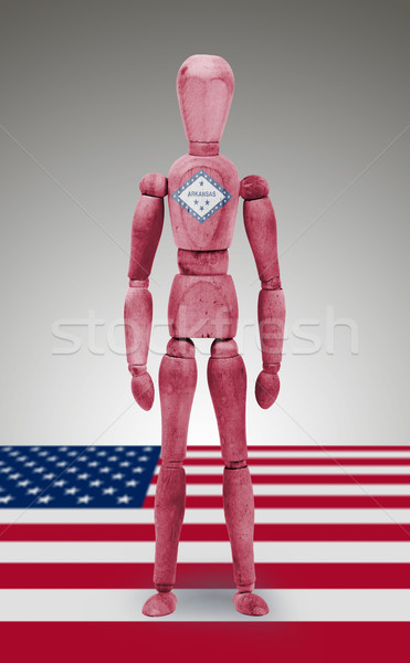 Stock photo: Wood figure mannequin with US state flag bodypaint - Arkansas