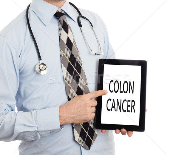 Stock photo: Doctor holding tablet - Colon cancer