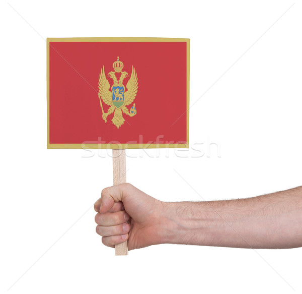 Stock photo: Hand holding small card - Flag of Montenegro