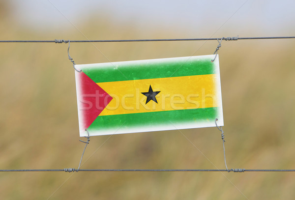 Border fence - Old plastic sign with a flag Stock photo © michaklootwijk