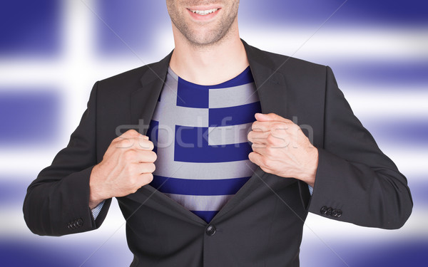 Businessman opening suit to reveal shirt with flag Stock photo © michaklootwijk