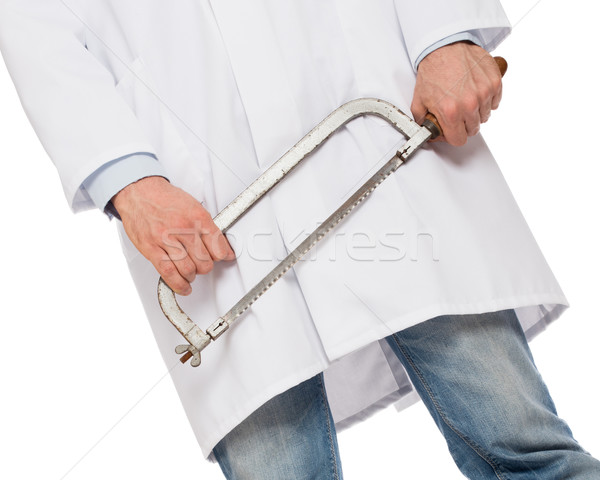 Crazy doctor is holding a big saw in his hands Stock photo © michaklootwijk