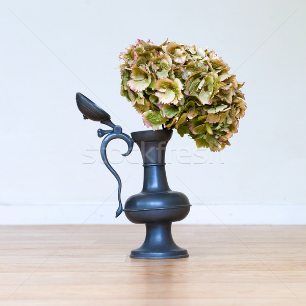 Stock photo: Flowers in an old tin vase