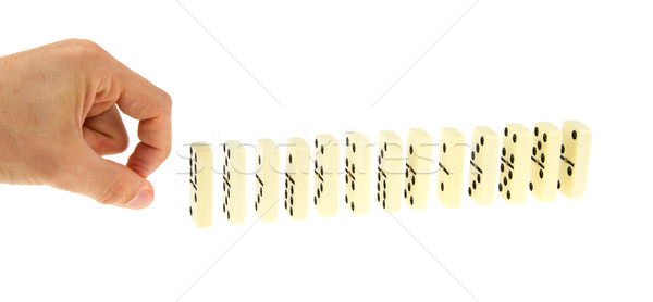 Hand ready to push dominoes Stock photo © michaklootwijk