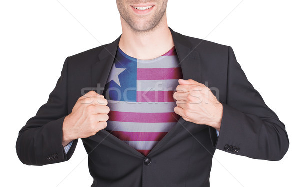 Businessman opening suit to reveal shirt with flag Stock photo © michaklootwijk