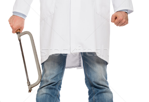 Crazy doctor is holding a big saw in his hands Stock photo © michaklootwijk
