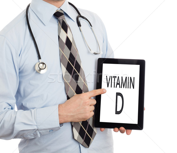Doctor holding tablet - Vitamin D Stock photo © michaklootwijk