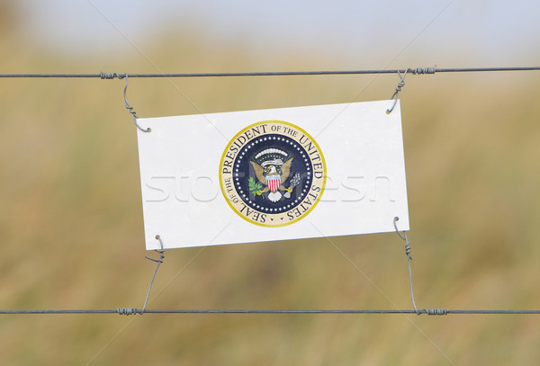 Border fence - Old plastic sign with a flag Stock photo © michaklootwijk