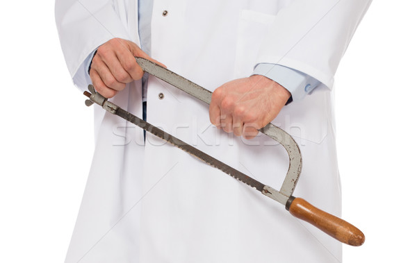 Crazy doctor is holding a big saw in his hands Stock photo © michaklootwijk