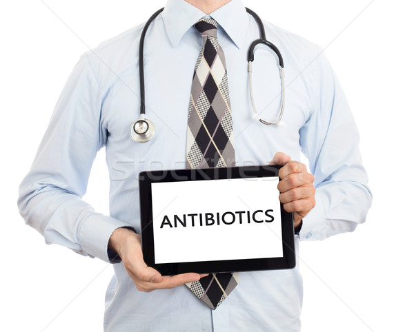 Arzt halten Tablet Antibiotika isoliert weiß Stock foto © michaklootwijk