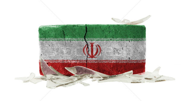 Cegły stłuczone szkło przemocy banderą Iran ściany Zdjęcia stock © michaklootwijk