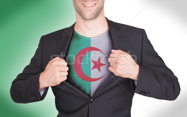 Businessman opening suit to reveal shirt with flag Stock photo © michaklootwijk