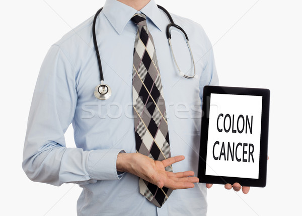 Doctor holding tablet - Colon cancer Stock photo © michaklootwijk