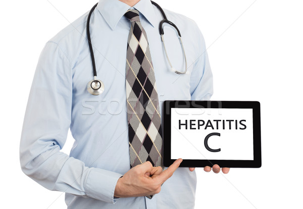 Doctor holding tablet - Hepatitis C Stock photo © michaklootwijk