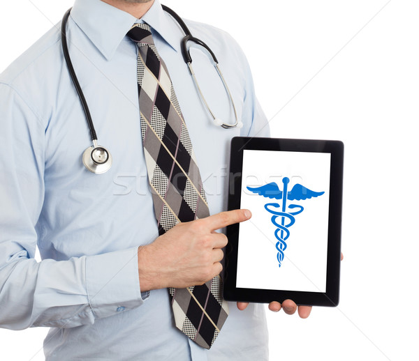 Doctor holding tablet - Caduceus symbol Stock photo © michaklootwijk