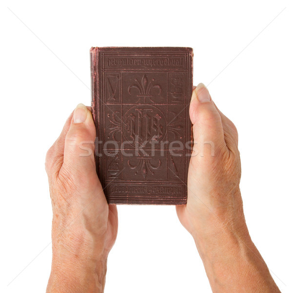 Old hands (woman) holding a very old bible Stock photo © michaklootwijk