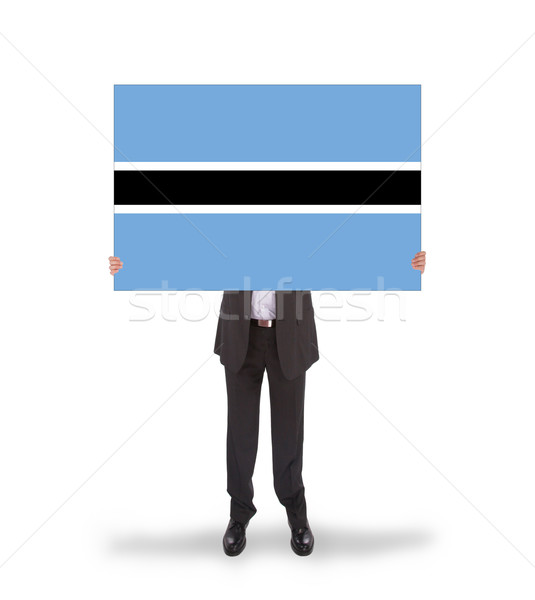 Businessman holding a big card, flag of Botswana Stock photo © michaklootwijk