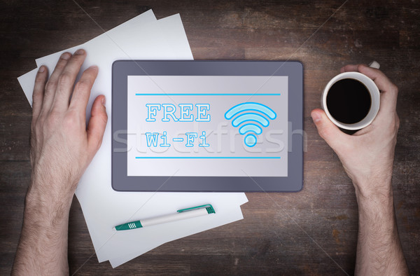 Tablet with Wi-Fi connection on a wooden desk Stock photo © michaklootwijk