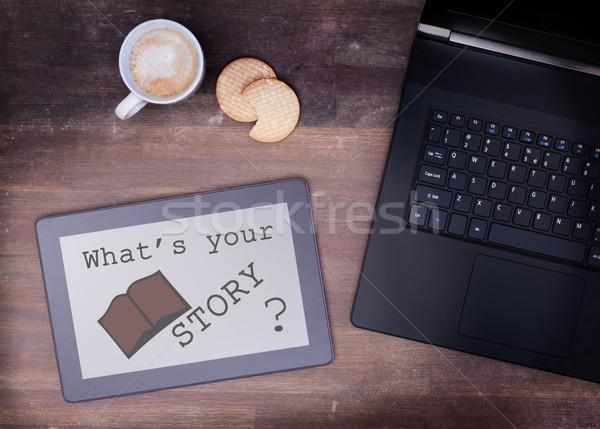 Tablet touch computer gadget on wooden table, what's your story Stock photo © michaklootwijk