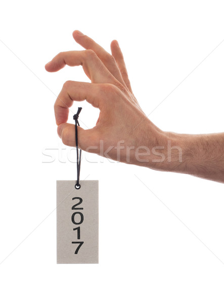 Stock photo: Hand holding a tag - New year - 2017