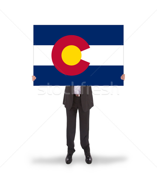 Smiling businessman holding a big card, flag of Colorado Stock photo © michaklootwijk