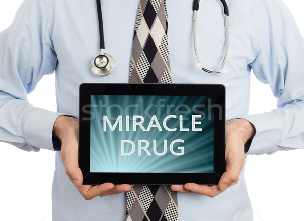 Orvos tart tabletta csoda drog izolált Stock fotó © michaklootwijk