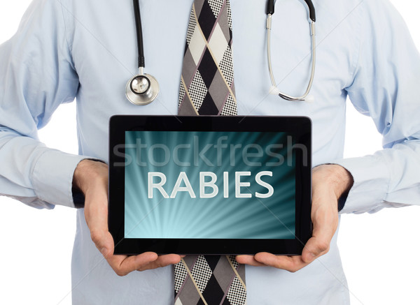 Doctor holding tablet - Rabies Stock photo © michaklootwijk