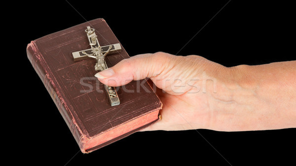 Old hand (woman) holding a very old bible Stock photo © michaklootwijk