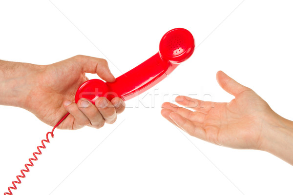 Man giving red telephone to woman Stock photo © michaklootwijk
