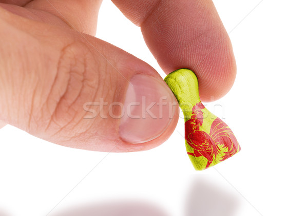 Hand holding wooden pawn, flag painting, selective focus Stock photo © michaklootwijk