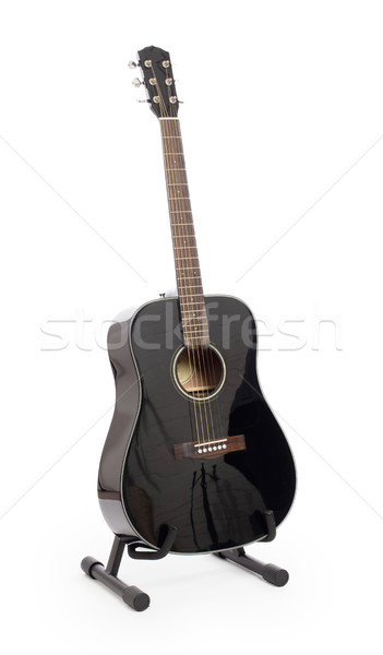 Black acoustic guitar on stand, isolated Stock photo © michaklootwijk