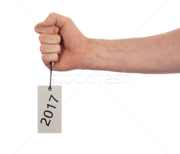 Hand holding a tag - New year - 2017 Stock photo © michaklootwijk