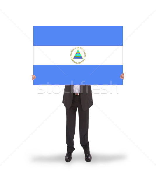 Businessman holding a big card, flag of Nicaragua Stock photo © michaklootwijk