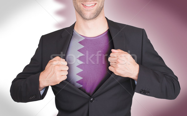 Businessman opening suit to reveal shirt with flag Stock photo © michaklootwijk