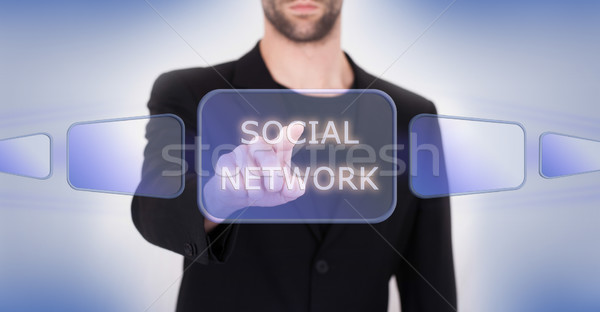 Business hand pushing the social media virtual button Stock photo © michaklootwijk