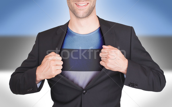 Businessman opening suit to reveal shirt with flag Stock photo © michaklootwijk