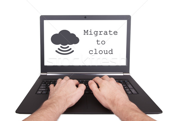 Man working on laptop, migrate to cloud Stock photo © michaklootwijk