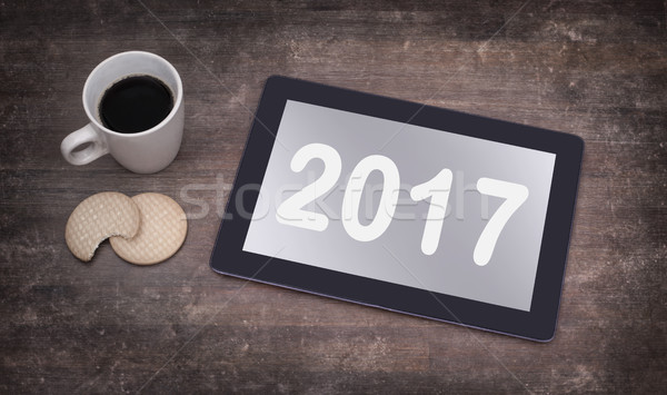 Tablet touch computer gadget on wooden table - 2017 Stock photo © michaklootwijk