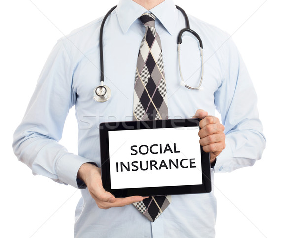 Stock photo: Doctor holding tablet - Social insurance