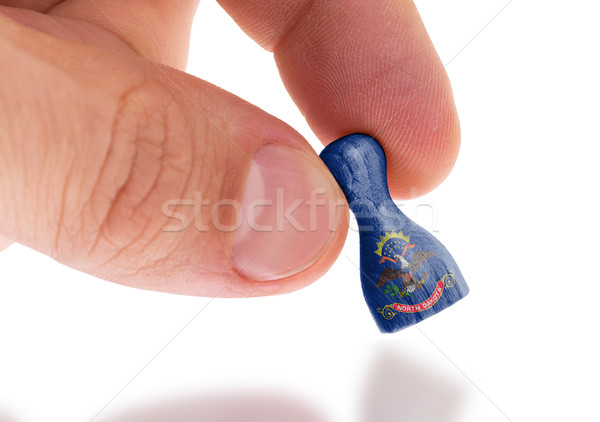 Hand holding wooden pawn, flag painting, selective focus Stock photo © michaklootwijk